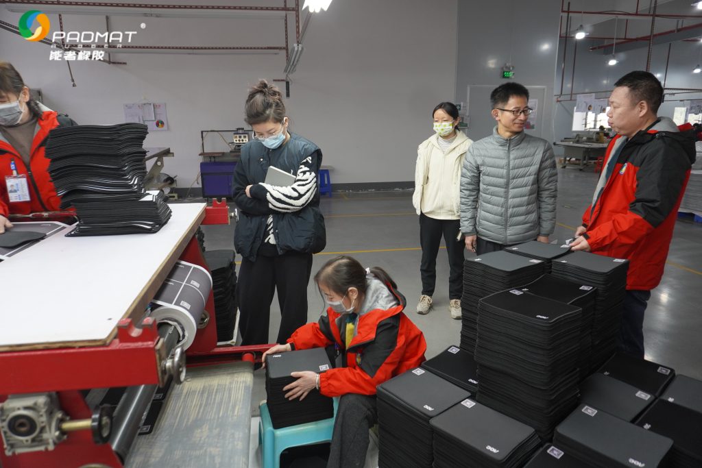 Professional mouse pad manufacturer’s packaging workshop, staff packing finished mouse pads efficiently.