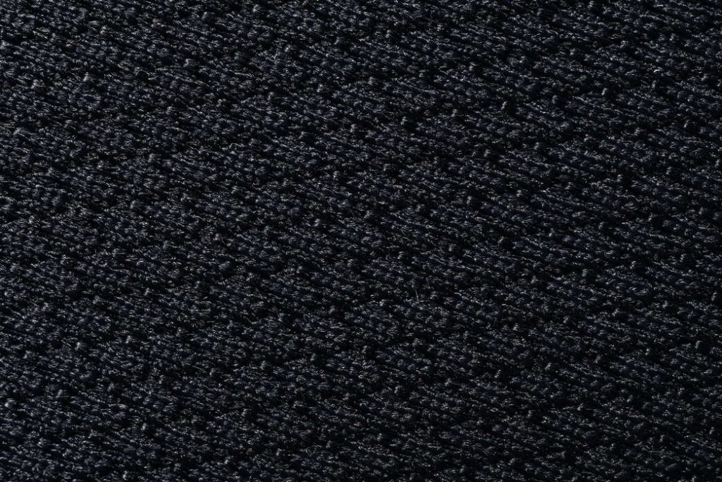 Black woven fabric texture close-up from Padmat Rubber custom mouse pad surface material