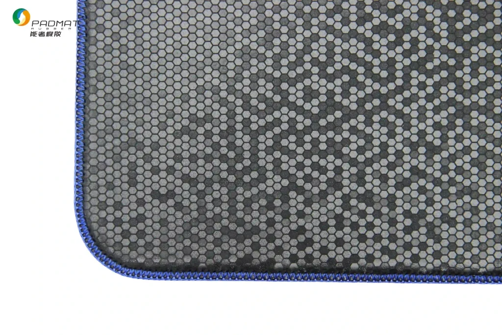 Sample display of PADMAT honeycomb‑textured gaming mouse pad, showing honeycomb surface texture and blue stitched edge detail