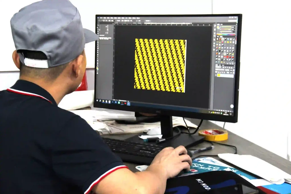 Custom mousepad design team at Padmat Rubber factory working on artwork for OEM mousepad printing