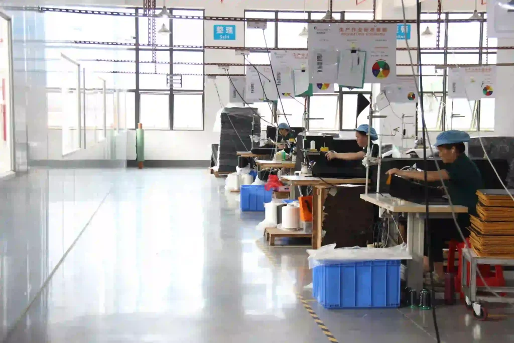 Custom mousepad lock stitching at Padmat Rubber factory with workers performing edge finishing on OEM mousepads