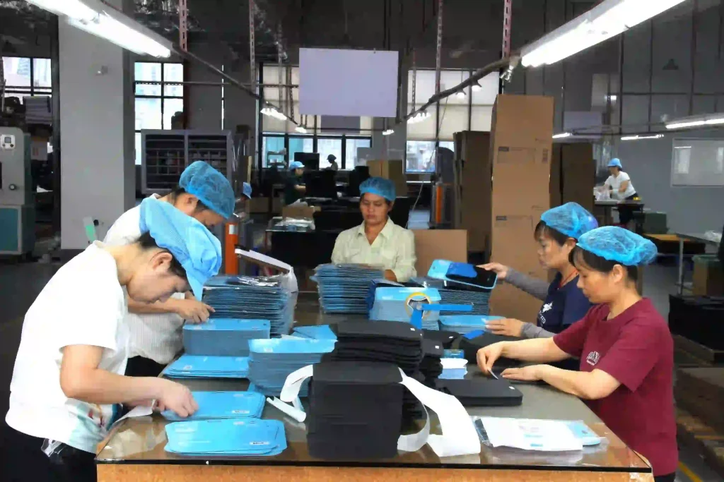 Custom mousepad packaging line at Padmat Rubber factory with workers packing finished OEM mousepads