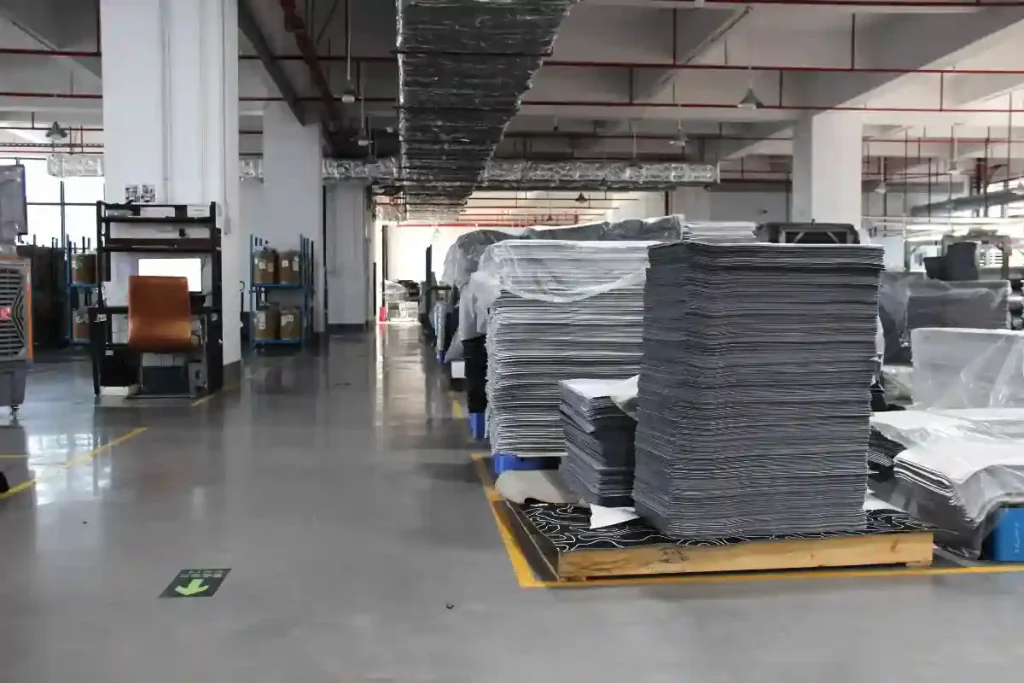 Custom mousepad warehouse at Padmat Rubber factory with large stacks of finished mousepads ready for OEM shipping