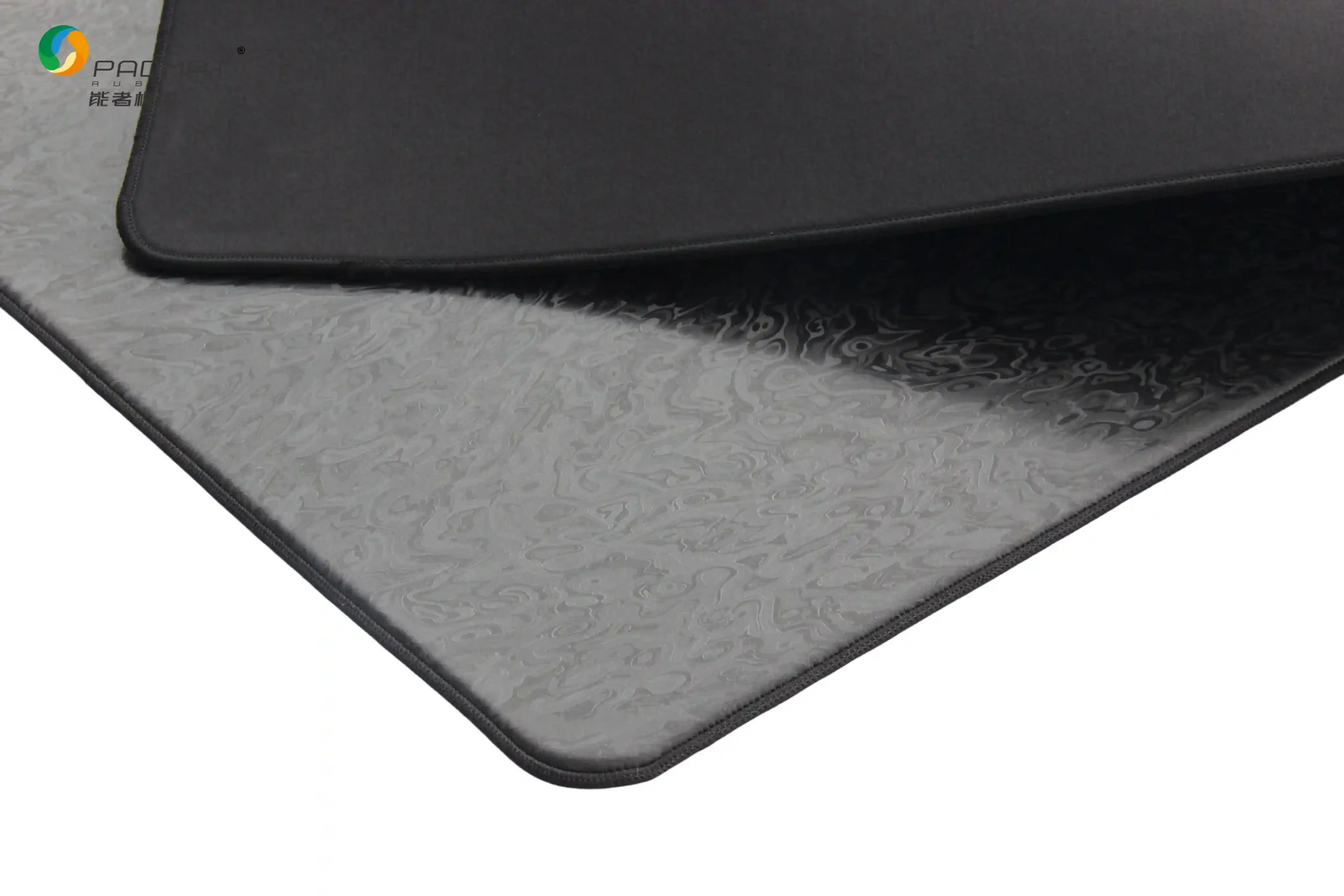 Close-up of Artifact Spirit gaming mouse pad showing black rubber base with woven texture for stable desk grip and anti-slip performance.