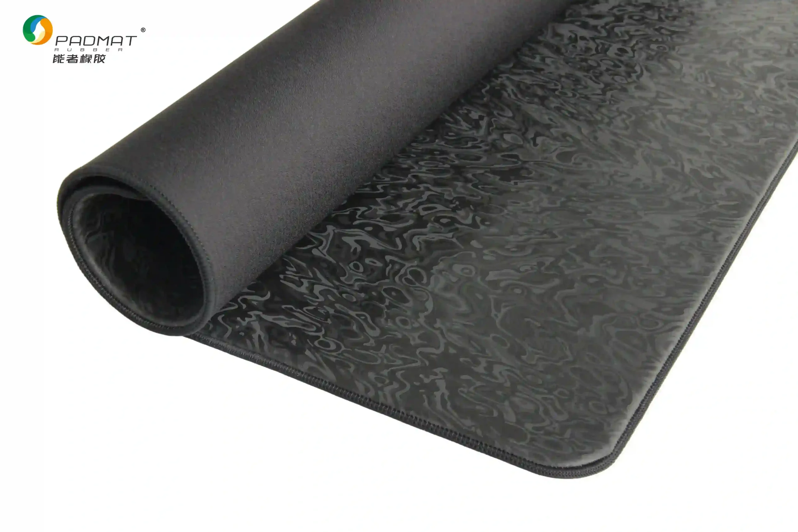 Close-up of Artifact Spirit gaming mouse pad rolled edge showing hexagonal jacquard texture and black stitching for ultra-fast control.
