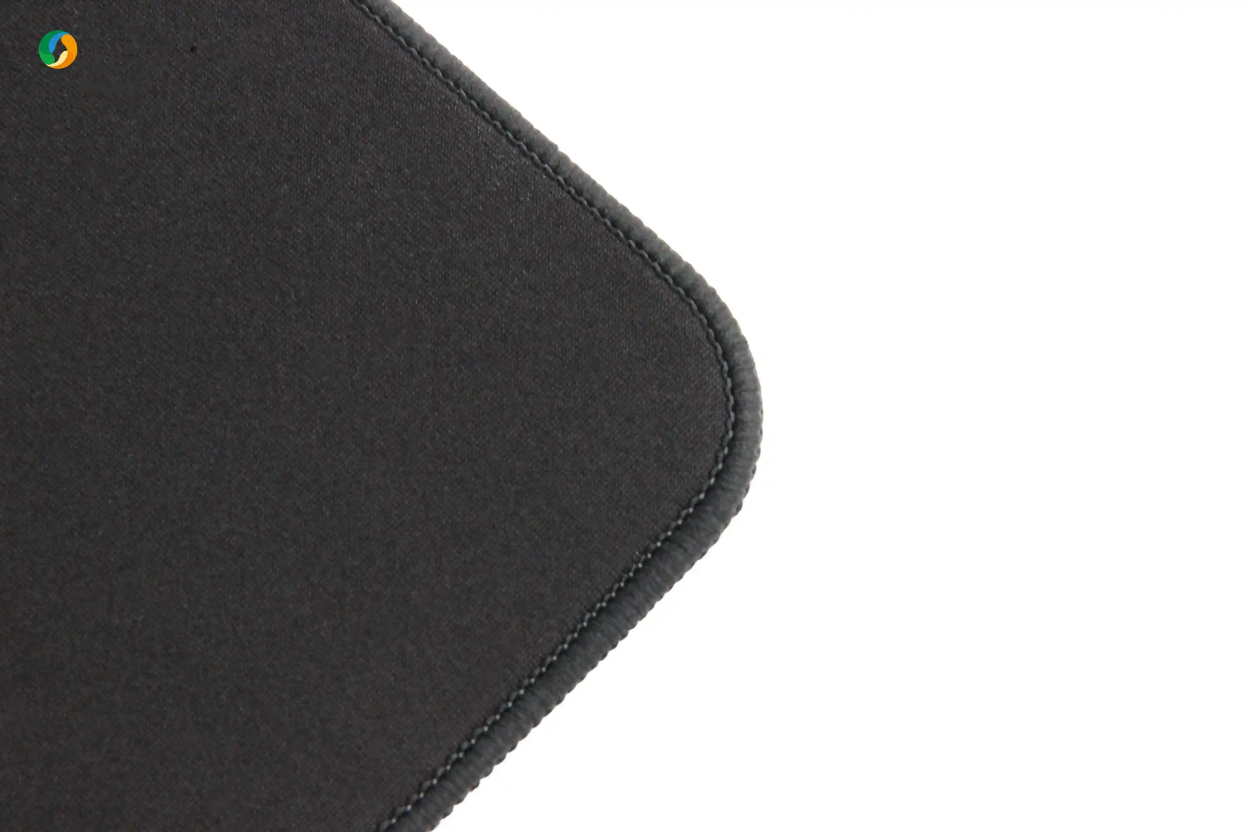 Close-up of Black Horse gaming mouse pad curved edge showing high-density fiber surface and narrow precision stitching for durable construction.
