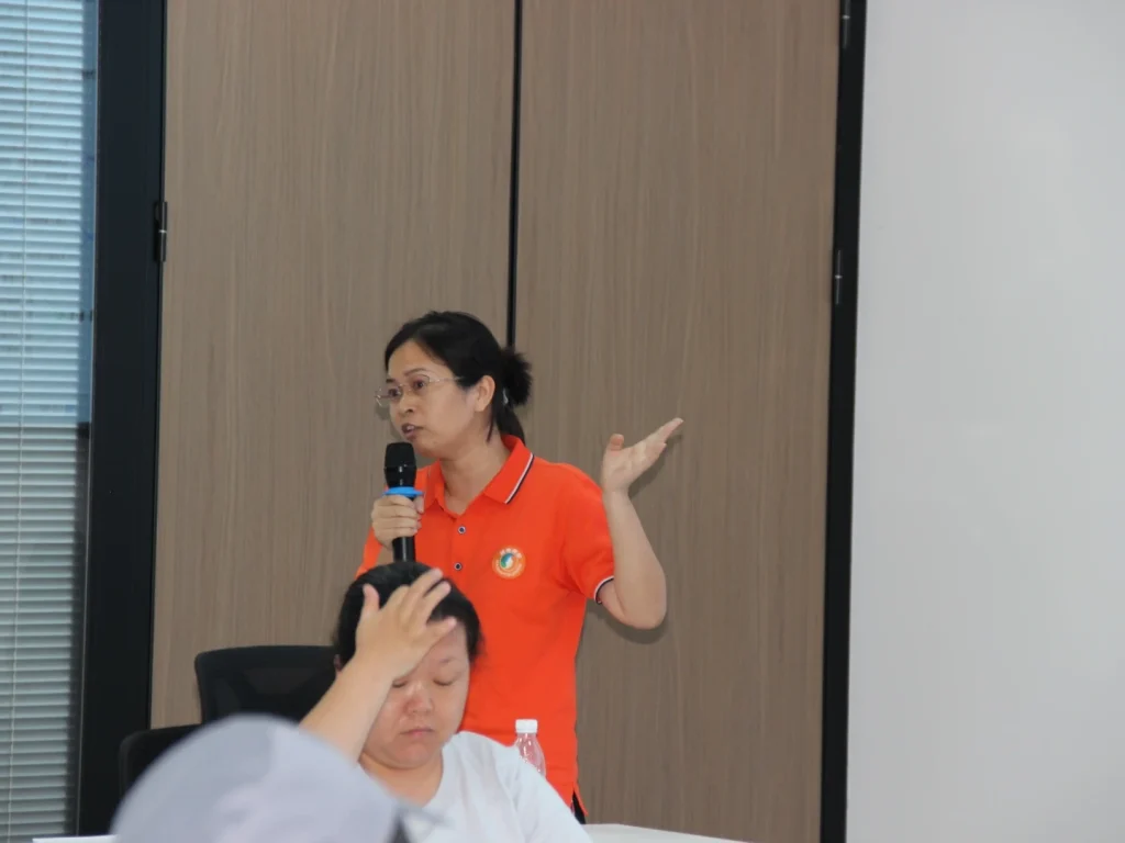 Core team member holding microphone to speak, putting forward practical suggestions on post skills, teamwork and training courses