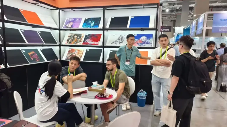 PADMAT booth at Computex exhibition, showing international clients consulting and discussing cooperation