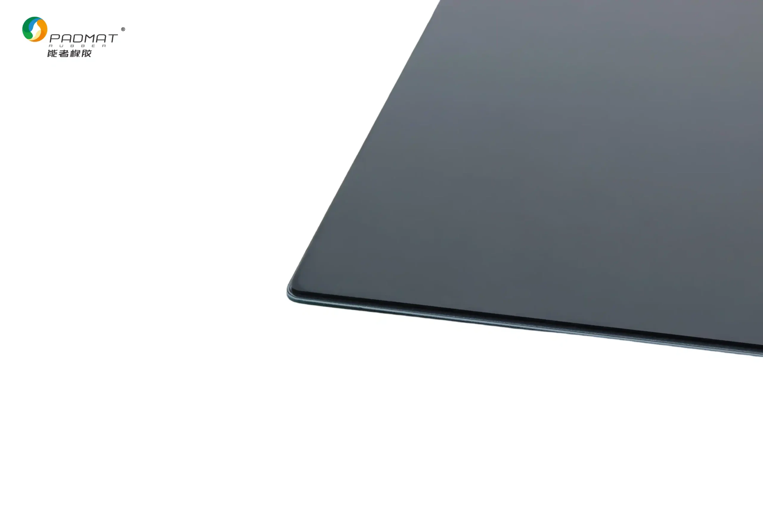 Close-up of Padmat glass gaming mouse pad in dark gray showing precision polished edge, smooth fine glass surface, and reflective finish.