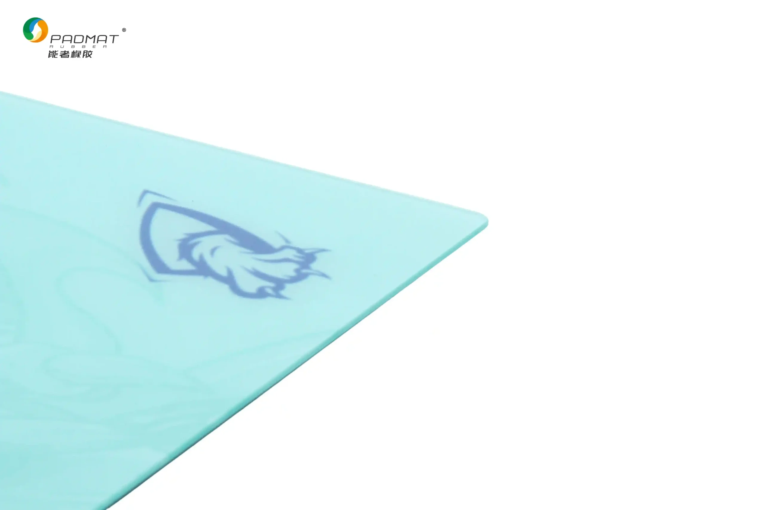 Close-up of Padmat glass gaming mouse pad showing precision polished edge and smooth fine glass surface with cyan color and logo detail.