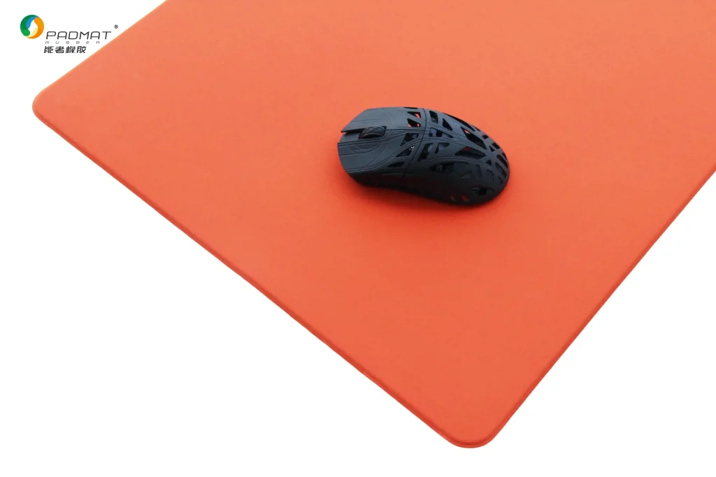 Shaoyang gaming mouse pad with solid orange surface and black lightweight gaming mouse, shown for balanced control and precise positioning.