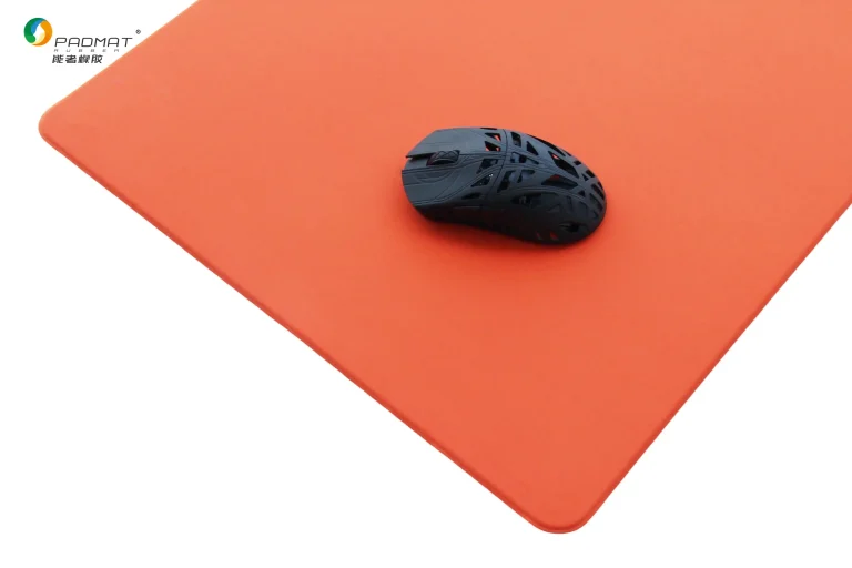 Shaoyang gaming mouse pad with solid orange surface and black lightweight gaming mouse, shown for balanced control and precise positioning.