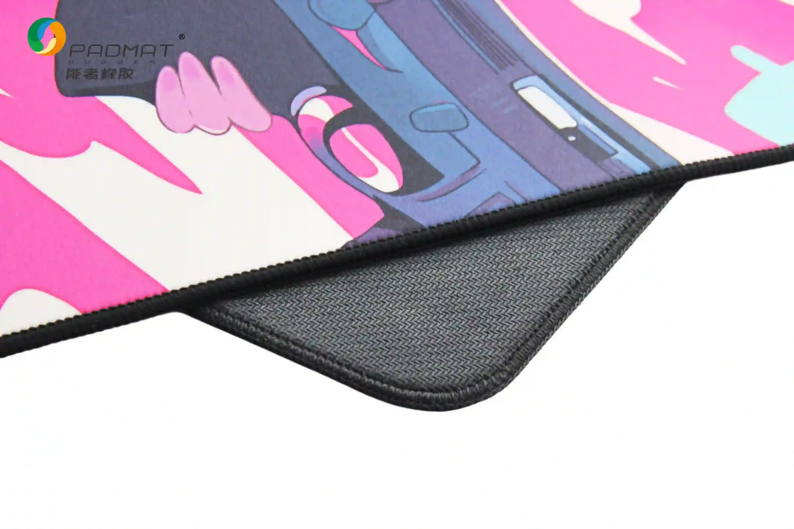 Close-up of Waterproof Pearl gaming mouse pad showing black rubber base with woven texture and edge stitching for stable desk grip.