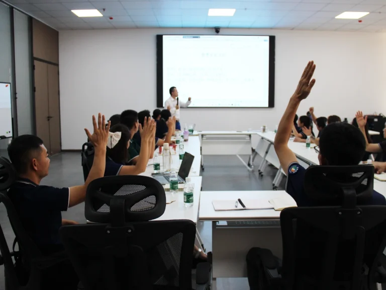 Team members at Padmat Rubber raising hands to vote and fully approve the finalized corporate culture values during the workshop.