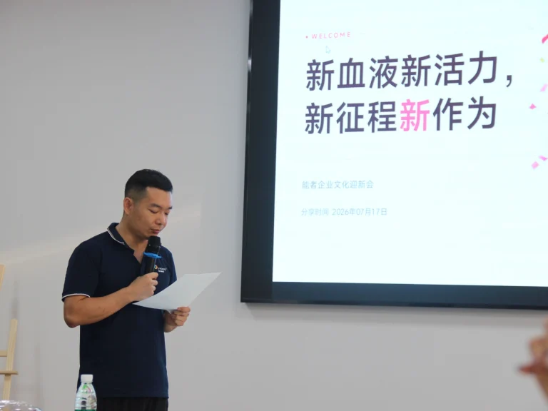 Factory manager holding speech script speaking at new employee welcome meeting, screen theme: New blood brings new vitality, new journey creates new achievements